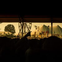 Looking out to the tent and ferris whell from a pavilliion at Bonnaroo. June, 2007. | Blurbomat.com