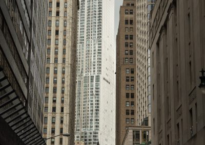 The New and The Old - Manhattan canyon looking at a gleaming Frank Gehry work with undulating façade. | Blurbomat.com