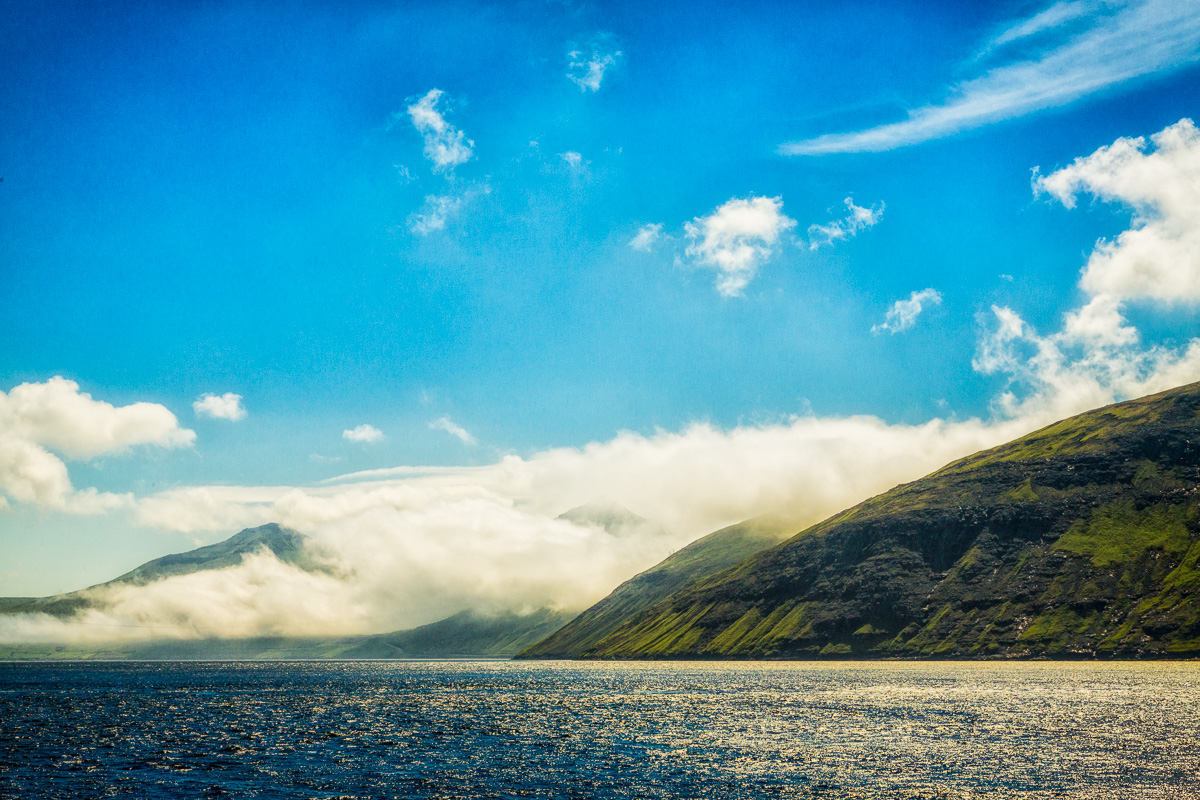 Clouds envelope a land mass, Faroe Islands - Blurbomat.com