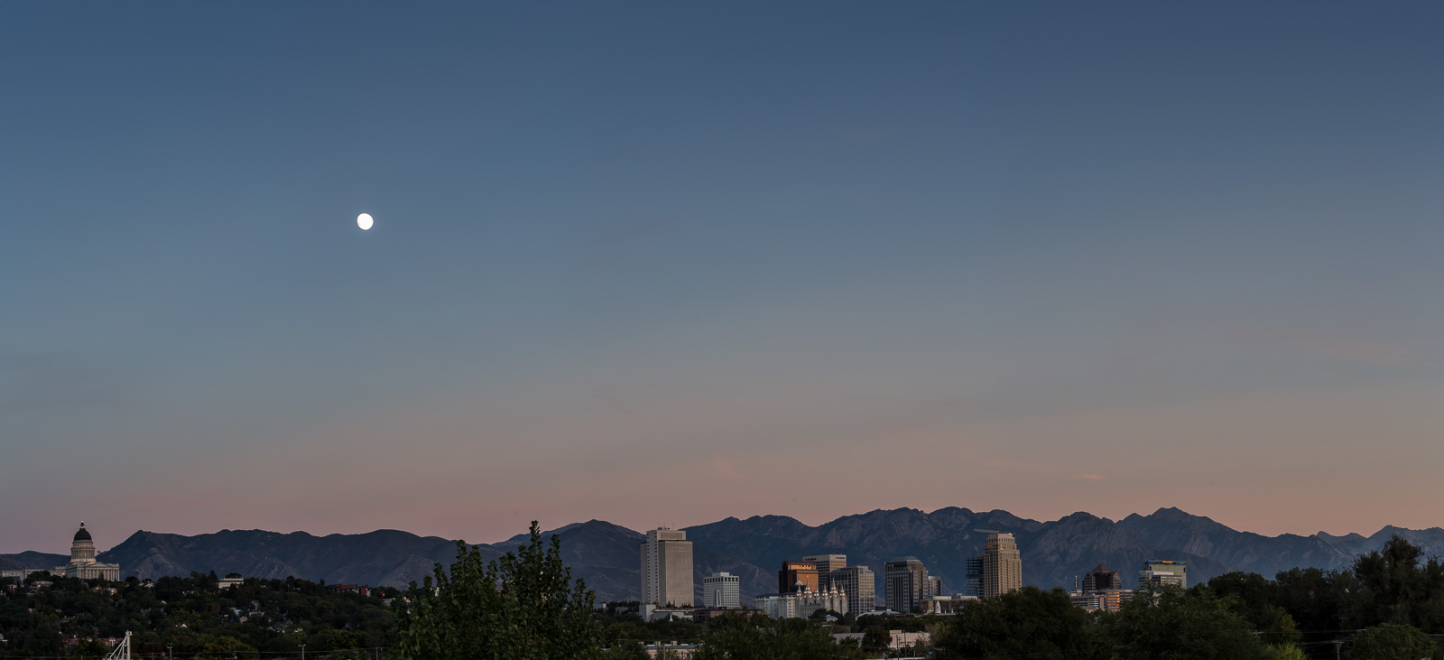 Salt Lake City, Utah skyline. State Capitol building on the left; LDS Temple center. Semptember, 2015.